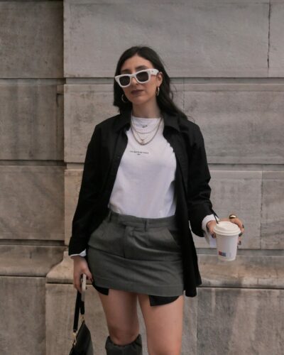Black oversized unisex Taste Shirt styled open over a white T-shirt