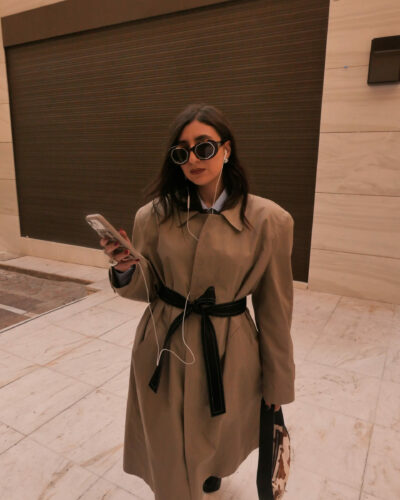 Front view of beige tailored trench coat with structured shoulders