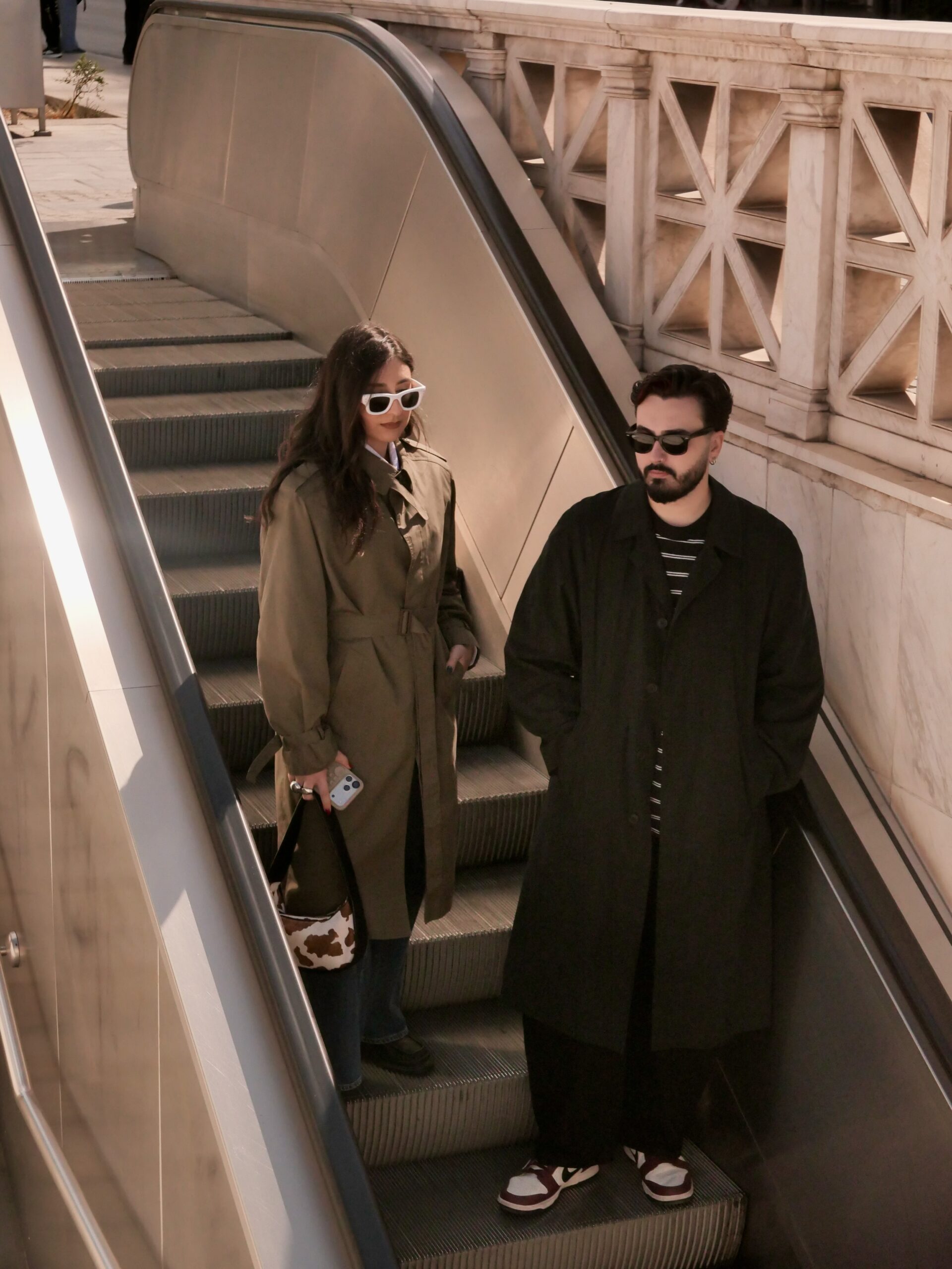 Front view of khaki tailored trench coat with structured shoulders